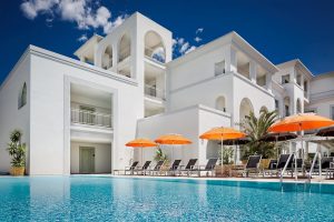 a picture of the outdoor pool and sun terrace at the jazz hotel in olbia