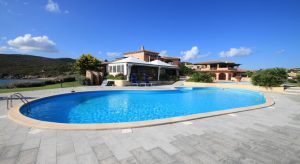 The seafront S'Abba e Sa Pedra apartments with outdoor pool.