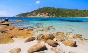 a picture of some rocks scattered around the beach of Cala Pira in south-east Sardinia