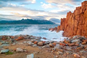 a picture of red rocks and turquoise waters near the coast of tortoli in east sardinia italy