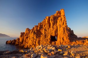 a picture of Rocce Rosse, a red rock formation in Arbatax, east Sardinia, Italy.