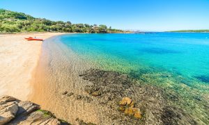 a picture of a pedal boat at lspiaggia liscia di vacca in costa smeralda sardinia