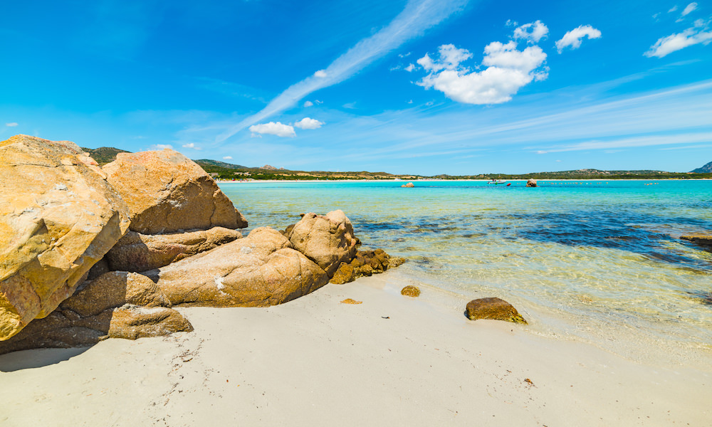 a picture of blue skies over lu impostu beach near san teodoro sardinia