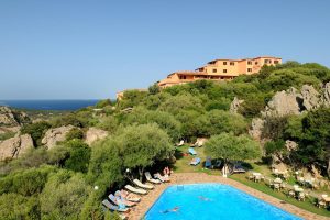 a picture of the outdoor pool at hotel rocce sarde in portisco sardinia