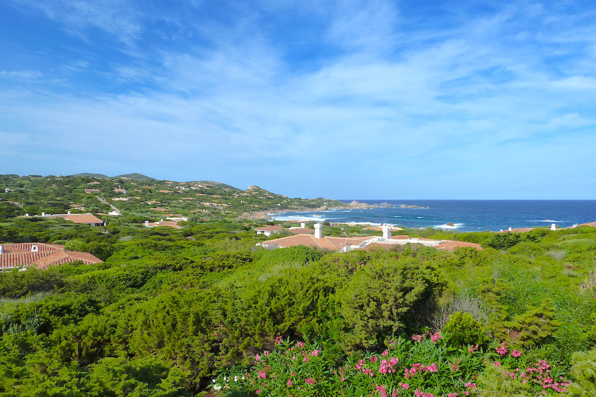 a picture of villa rooftops and lush green hills near Portobello, north Sardinia, Italy.