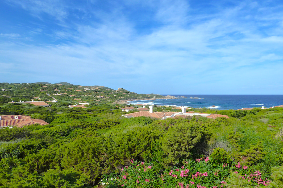 a picture of villa rooftops and lush green hills near Portobello, north Sardinia, Italy.