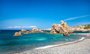 a picture of rocks in the water at tinnari beach in north sardinia