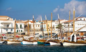 a picture of sailing boats anchored at the port of San Teodoro Sardinia