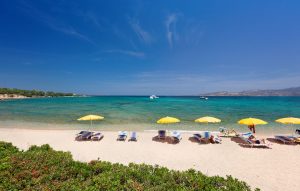 a picture of people on the beach of spiaggia mannena in cannigione north-east sardinia italy