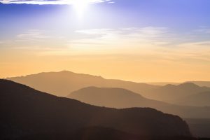 a picture of a sunset in the mountains of Sardinia, Italy.