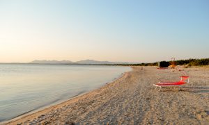 a picture of is solinas beach at sunset