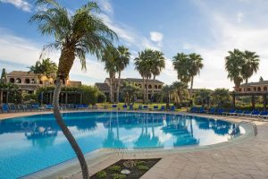 a picture of the sun terrace and outdoor pool at Lantana Resort Hotel & Apartments in Pula, south Sardinia, Italy.