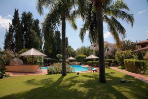a picture of the garden and outdoor pool at the Nora Club Hotel in Pula, south Sardinia, Italy.