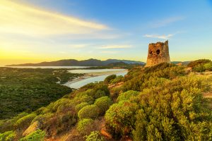 a picture of the old watchtower named Torre di Porto Giunco, in Villasimius, south-east Sardinia, Italy.