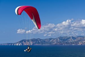 a picture of someone paragliding in Sardinia, Italy.