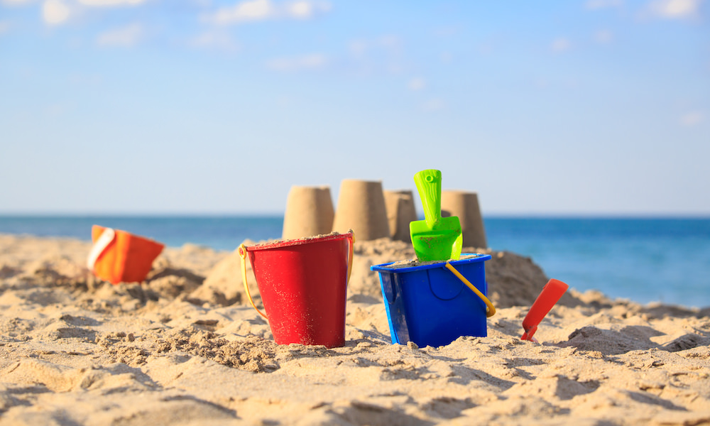 a picture of a bucket and scoop on the beach