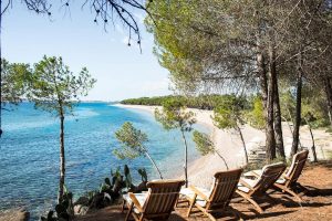 a picture of the private beach at the four-star lanthia resort in sardinia italy