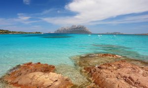 a picture of isola tavolara seen from the beach of porto istana in olbia tempio sardinia