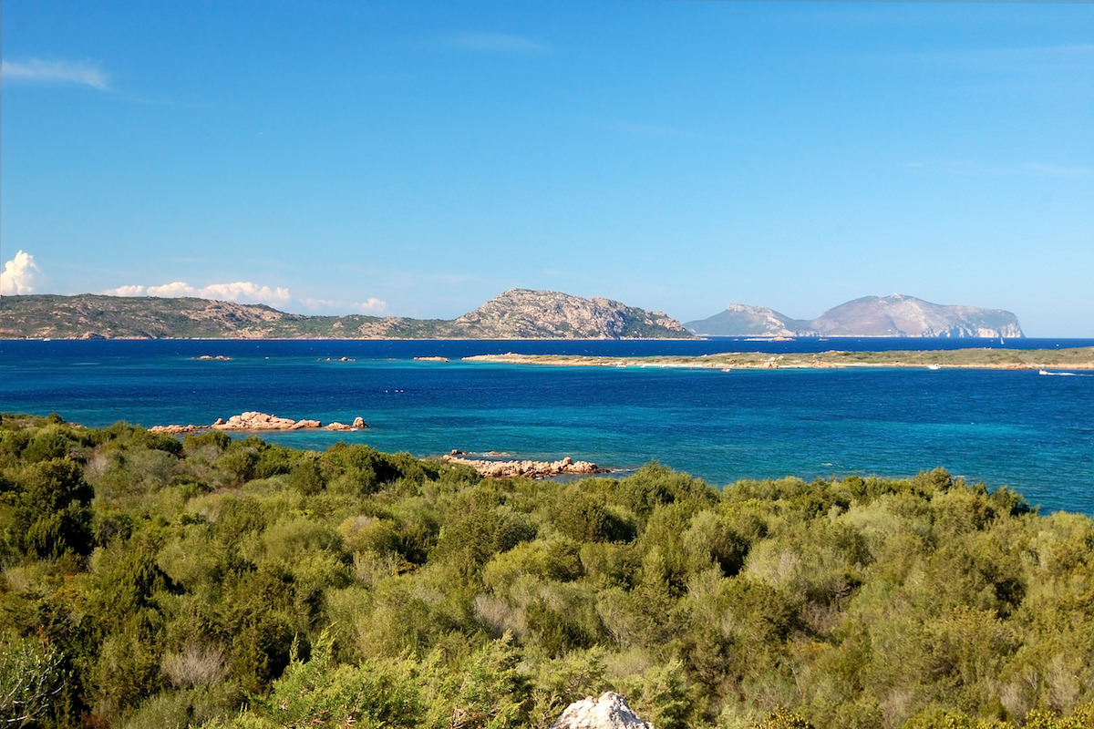a picture of the blue waters and lush vegetation near Porto San Paolo, north-east Sardinia, Italy.