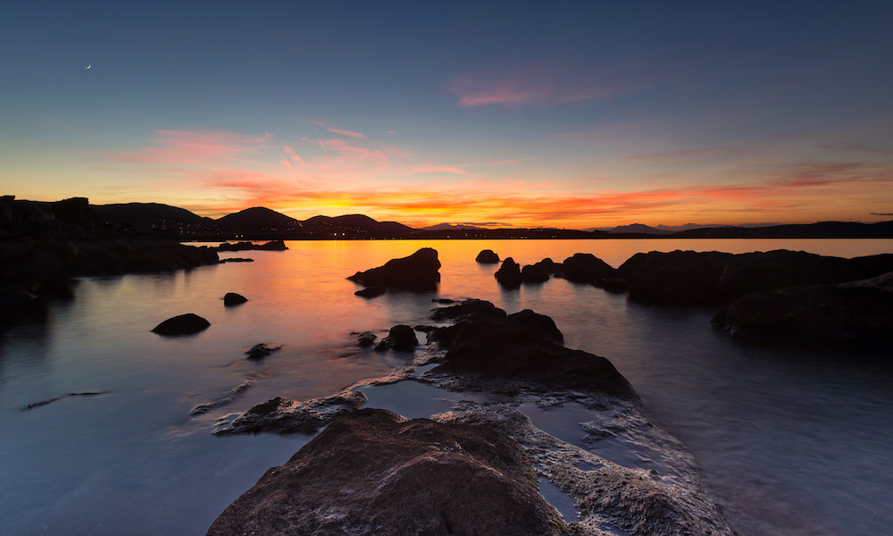 a picture of a warm sunset at the beach of punta don diego in north-east sardinia