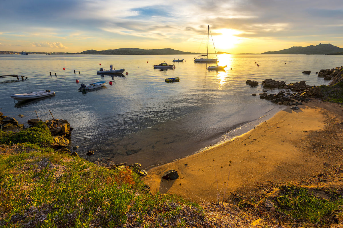 a picture of small boats anchored at Spiaggia di Porto Faro, in Palau, north Sardinia, Italy.