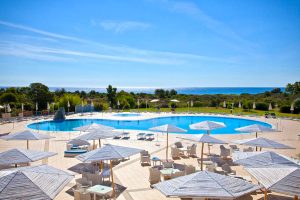 a picture of the large outdoor pool and sun terrace at Hotel Baia Del Porto, a four-star hotel in Porto Ottiolu, north-east Sardinia, Italy.