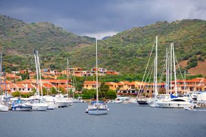 a picture of yachts and sailing boats anchored at the marina of Porto Ottiolu, in north-east Sardinia, Italy.