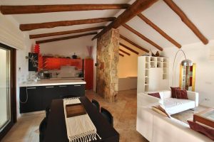 a picture of the living room and kitchen of Villa Arena in Porto Rotondo, north-east Sardinia, Italy.