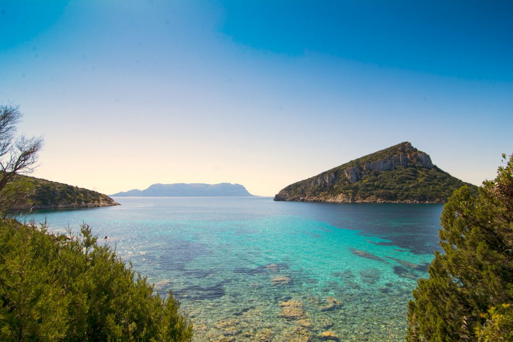 a picture taken at Cala Moresca, with views of Isola Tavolara and Isola di Figarolo, in Golfo Aranci, north-east Sardinia, Italy.