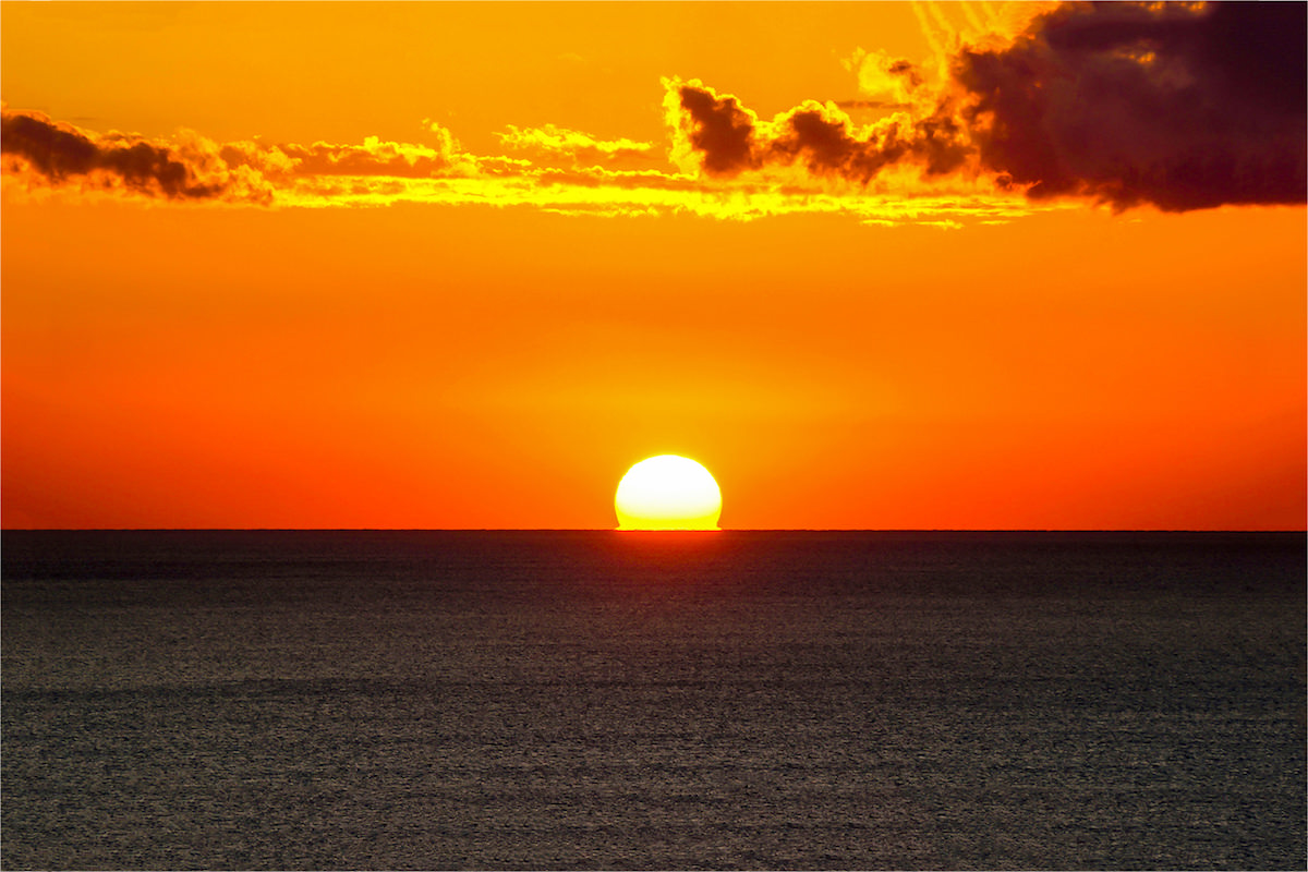 a picture of a sunset at the beach