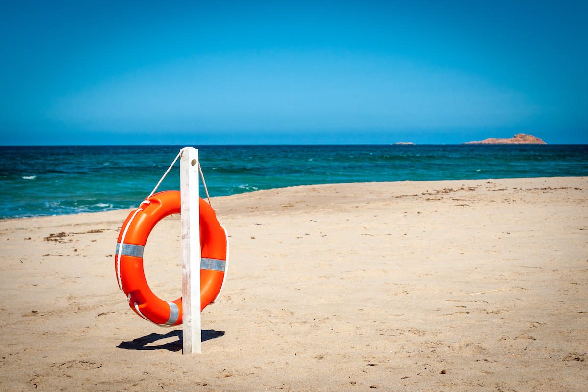 a lifebuoy on the beach of Li Junchi, in Badesi, north Sardinia, Italy.