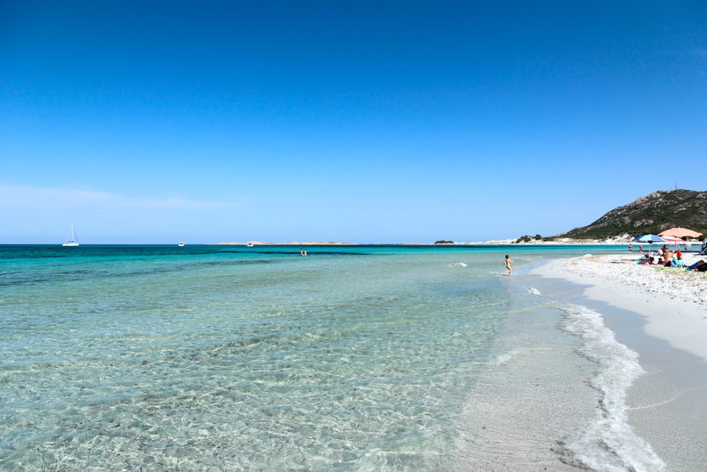 a picture of children playing at Spiaggia di Capo Comino, near Siniscola in the province of Nuoro, east Sardinia, Italy.