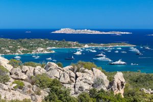 several luxury yachts in the bay of Cala di Volpe, in Costa Smeralda, Sardinia, Italy.