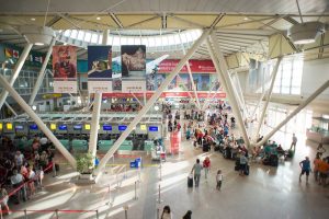 the spacious departure terminal at Olbia Costa Smeralda Airport in north-east Sardinia, Italy.