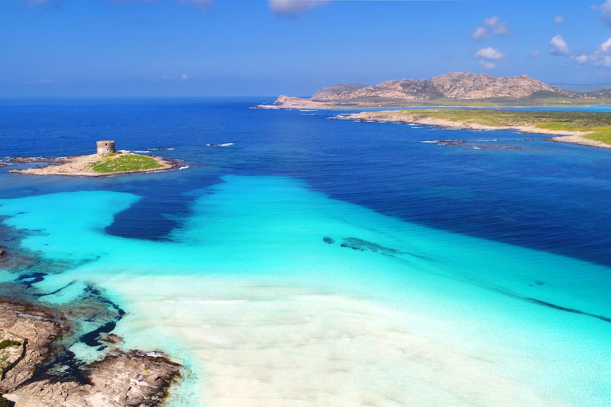 a stunning aerial view of Spiaggia La Pelosa, in Stintino, north-west Sardinia, Italy.