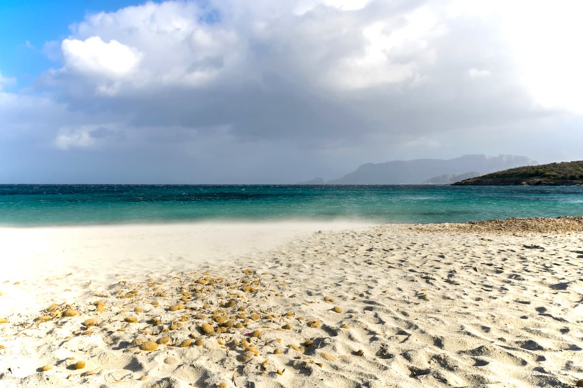 the white and fine sands of the beach named Spiaggia di Bados, in Pittulongu, north-east Sardinia, Italy.