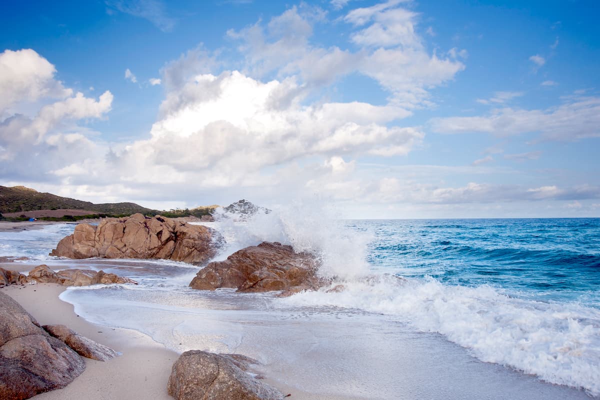waves crashing on a few rocks at the beach of Cala Liberotto in east Sardinia Italy