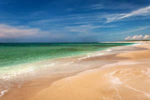 blue waters and quartz grains of sand at Spiaggia di Maimoni in west Sardinia, Italy.