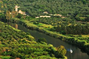 lush green landscapes near the Catholic church along the Fiume Temo rover in Bosa west Sardinia, Italy.