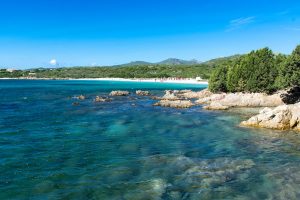 crystal clear blue waters at the beach named Spiaggia Cala Banana, near the city of Olbia, in north-east Sardinia, Italy.