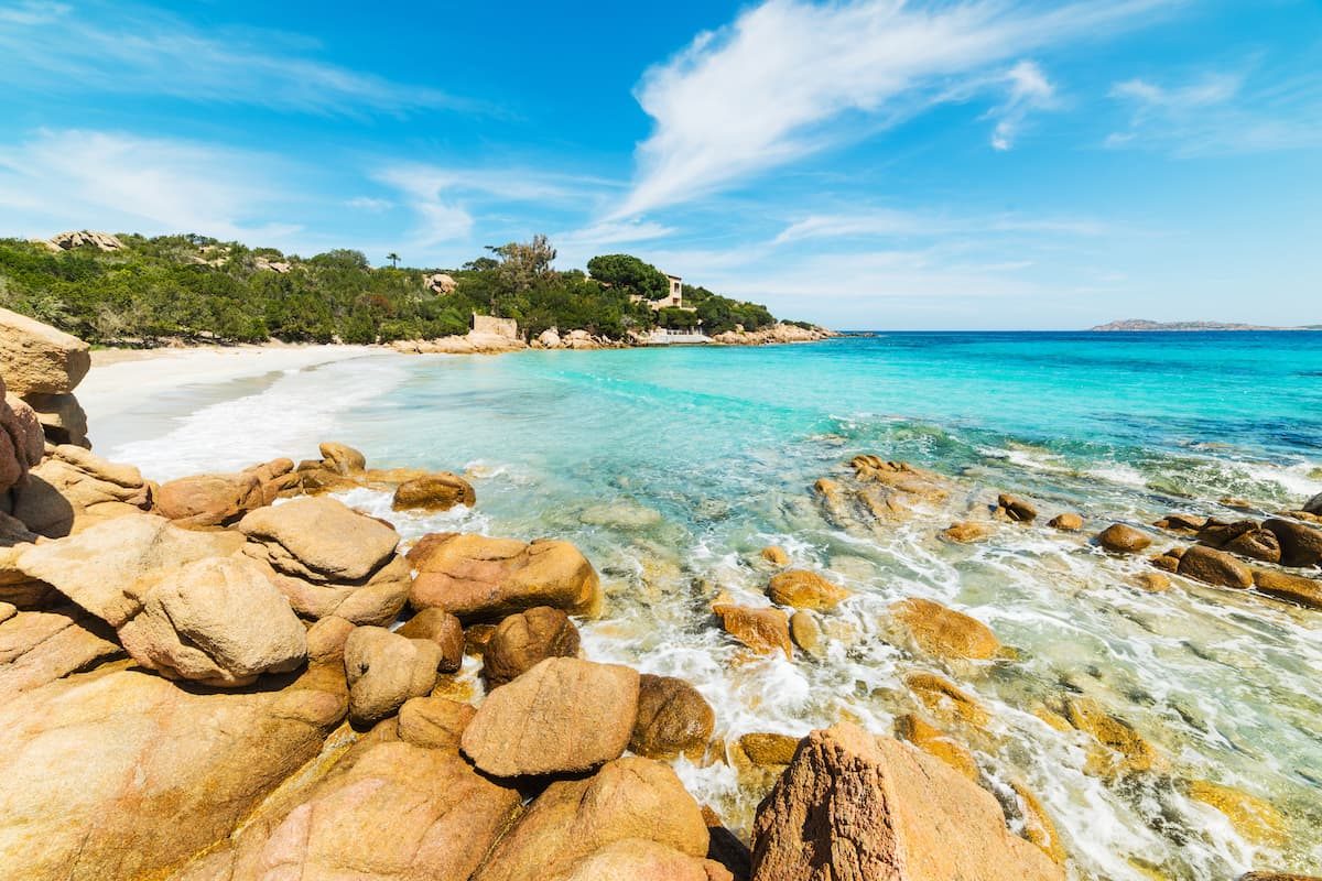 Picture-perfect Spiaggia Capriccioli, near Cala di Volpe, Costa Smeralda, Sardinia. In the background, the small mountains of Isola Mortorio.