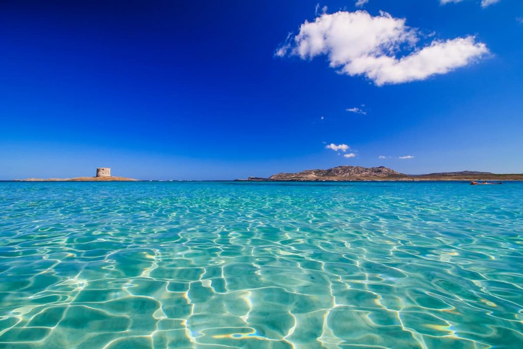 gorgeous transparent waters and blue skies at Spiaggia La Pelosa, in Stintino north-west Sardinia, Italy.