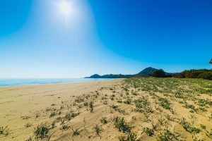 the sun shines over Spiaggia di Feraxi in south-east Sardinia, Italy.