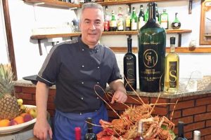 a picture of the owner of restaurant da robertino in palau, sardinia, italy.