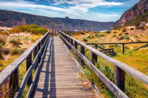 cala domestica wooden pathway to the beach