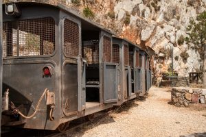 Old mine carts in the Planu Sartu mine tunnel Galleria Henry near the mining village of Buggerru, Sardinia Italy