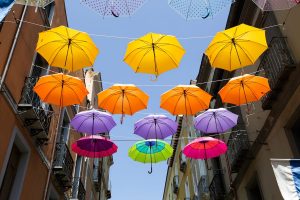 colored umbrellas over the streets of iglesias sardinia