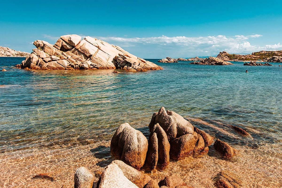 summer scenery of clear waters and granite rocks at Spiaggia dello Strangolato on Isola Maddalena, Sardinia.