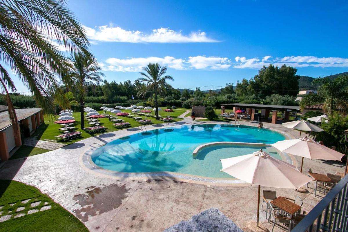 A view of the outdoor pool and sun terrace at the Alma Resort in Castiadas, Sardinia, Italy.