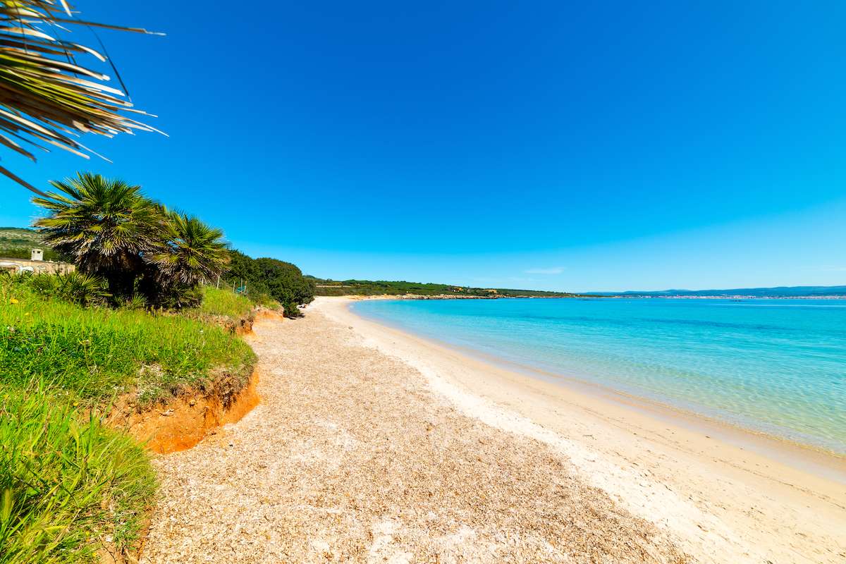 A view to the north along Spiaggia del Lazzaretto, one of the best beaches near Alghero, northwest Sardinia, Italy.